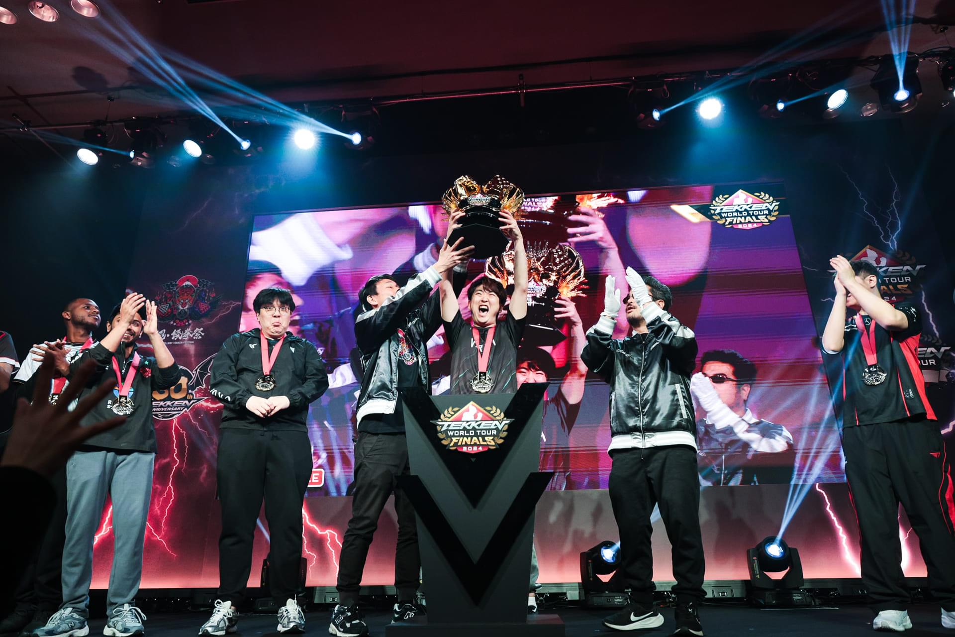 Award ceremony for the official Tekken 8 world tournament “TEKKEN World Tour 2024 Global Finals”, photo of the winner holding the trophy and participants celebrating